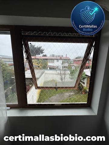 Malla de seguridad instalada en ventana con vista a la ciudad